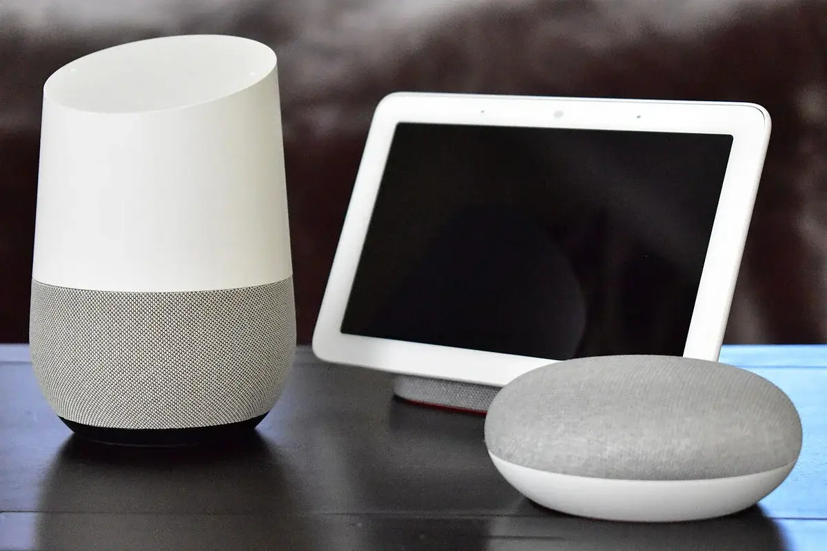 Google Home speaker, Home Hub display, and Home Mini on a table