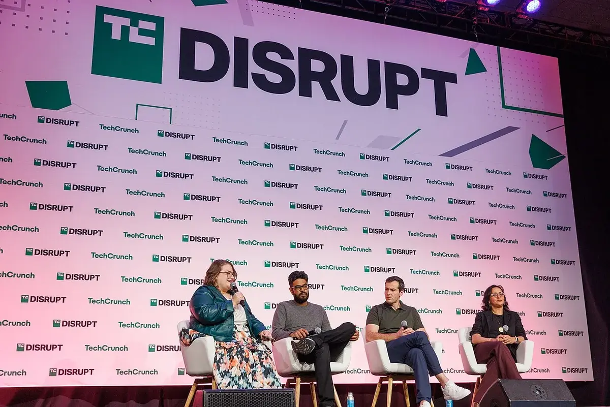 Panel discussion on stage at TechCrunch Disrupt 2024 with four speakers seated in front of a branded backdrop.