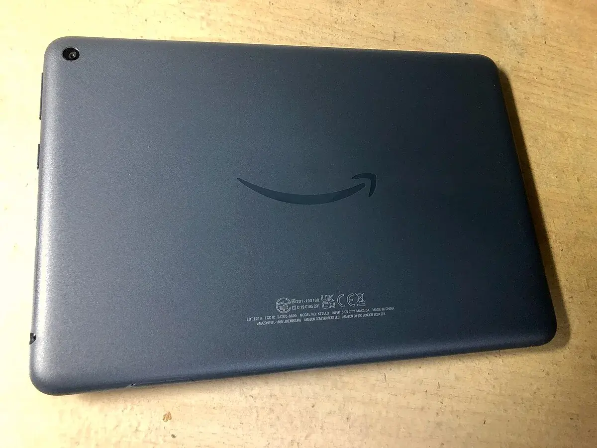 Back view of a Kindle Fire HD 8 Plus tablet on a wooden table.