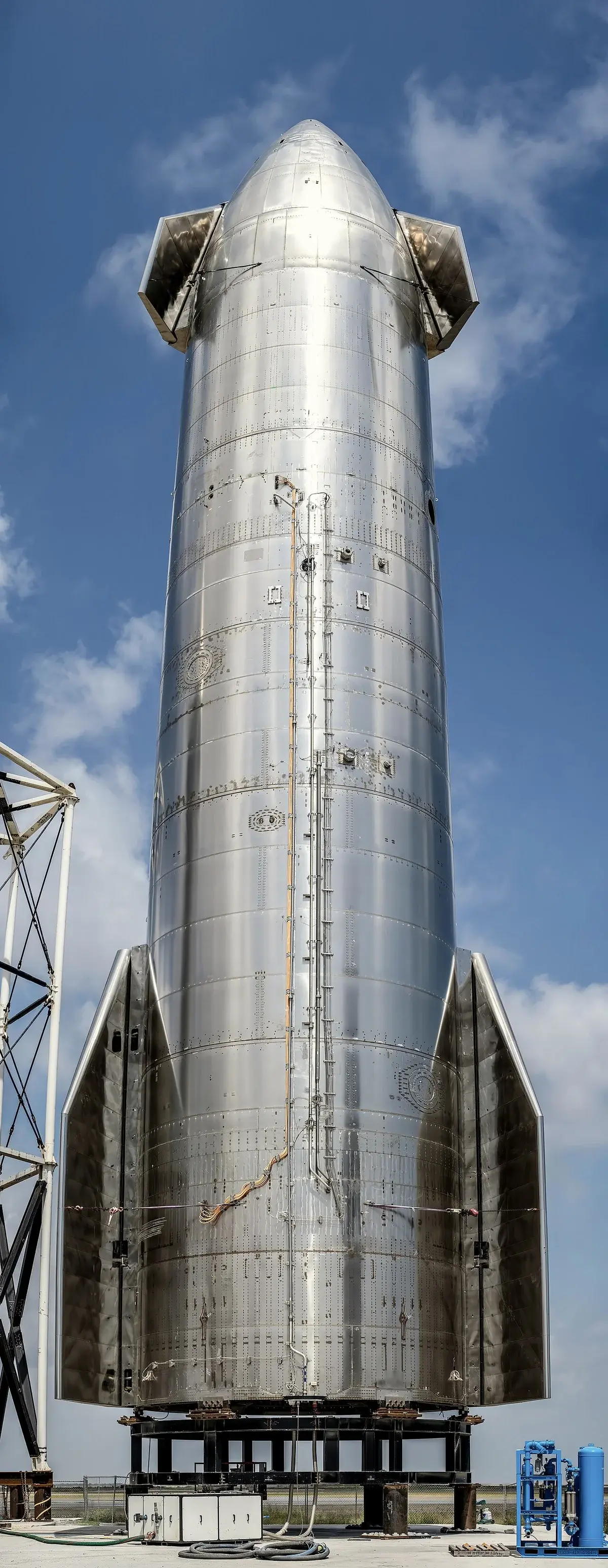 A SpaceX Starship prototype standing on a launch stand outdoors.