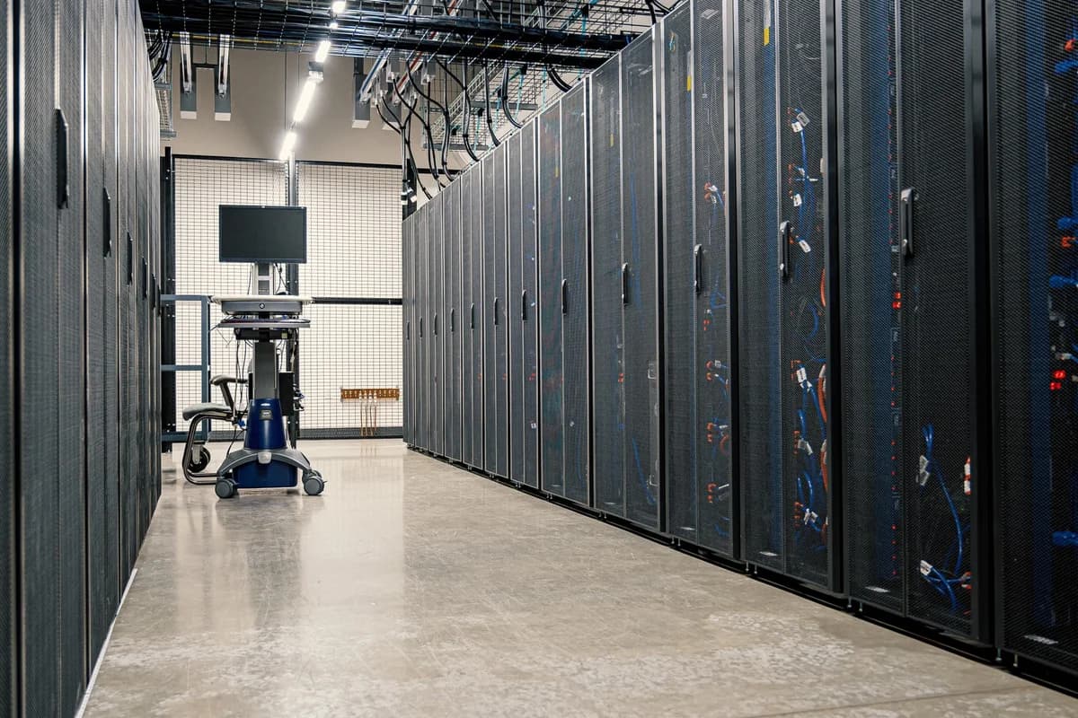 row of server cabinets with cables and a monitor in a data center