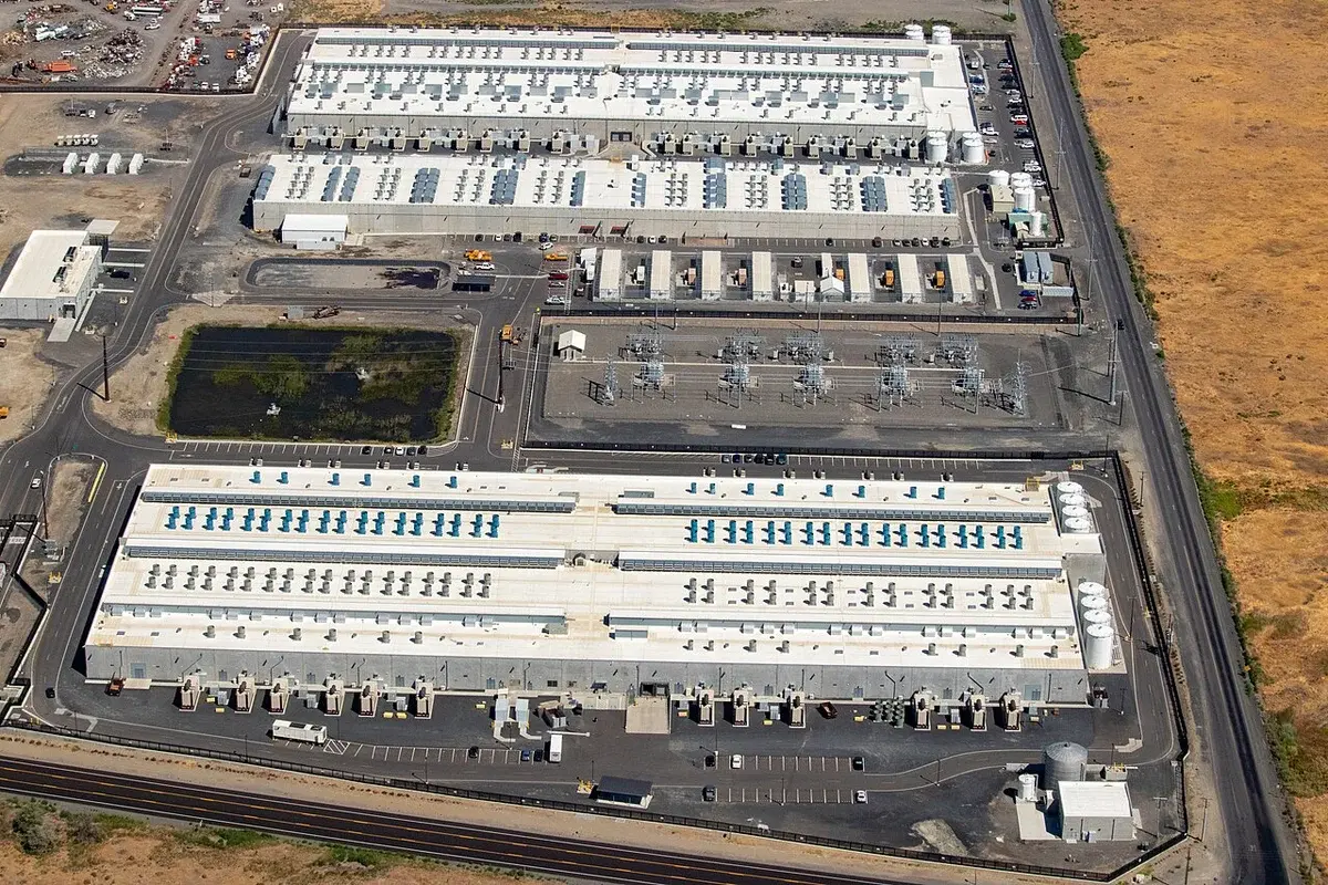 Aerial view of three large datacenter buildings in an AWS facility.