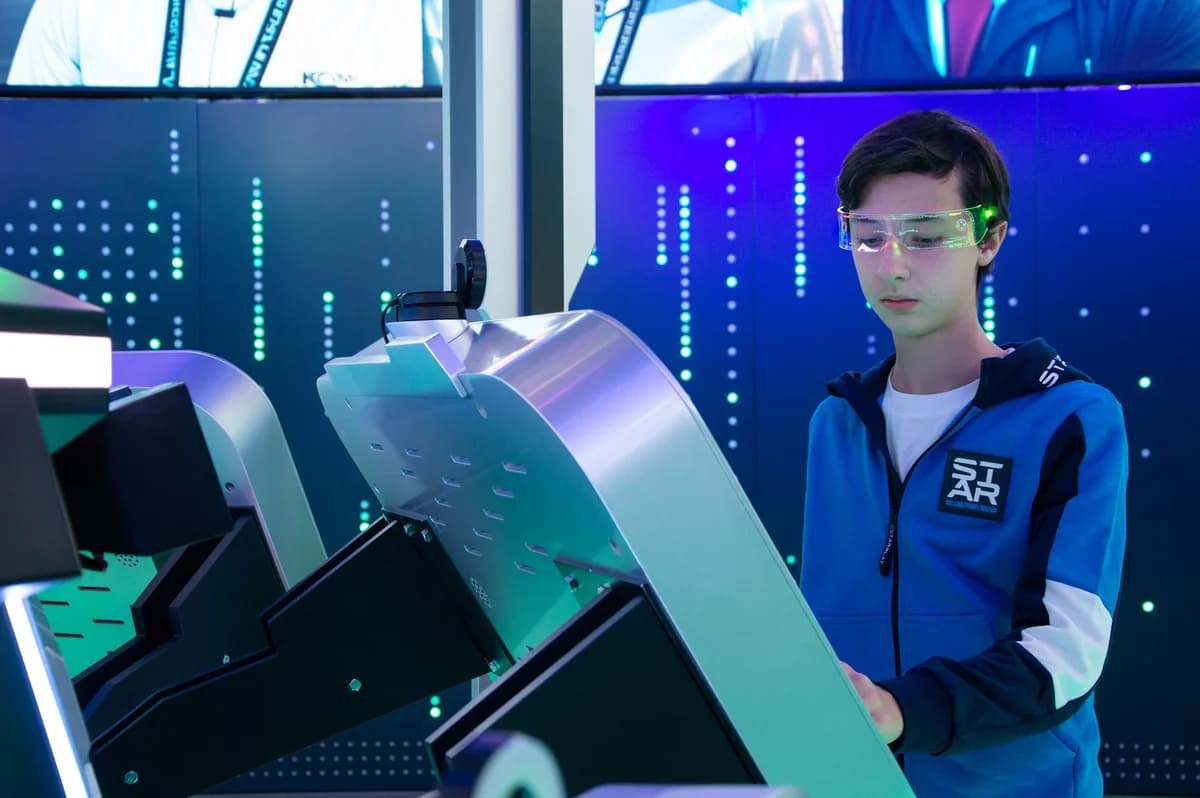 Teenager wearing smart glasses using an interactive tech display.